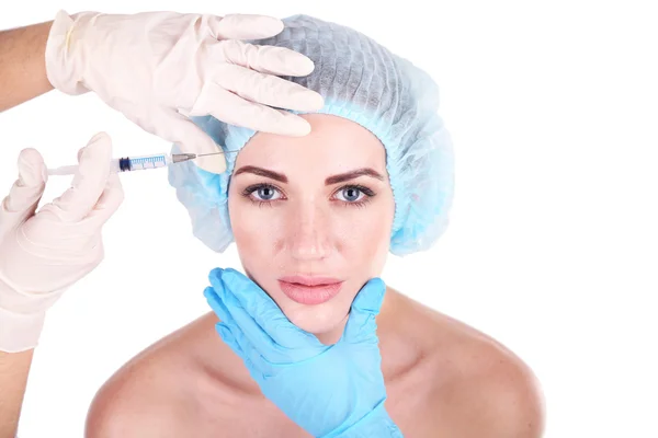 Woman in beauty clinic getting botox injection, isolated on white — Stock Photo, Image