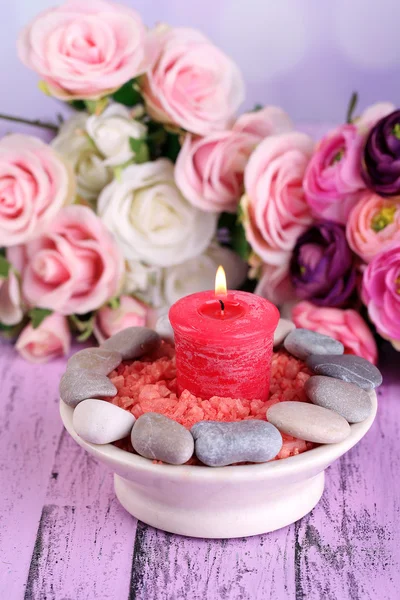 Composición con piedras de spa, velas y flores sobre mesa de madera de color, sobre fondo claro — Foto de Stock