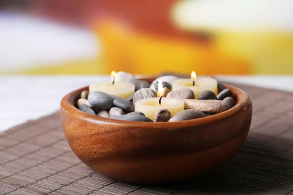 Composition with spa stones, candles on bamboo mat background — Stock Photo, Image