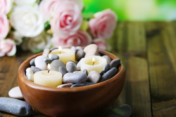 Composition with spa stones, candles  and flowers on  bright background — Stock Photo, Image
