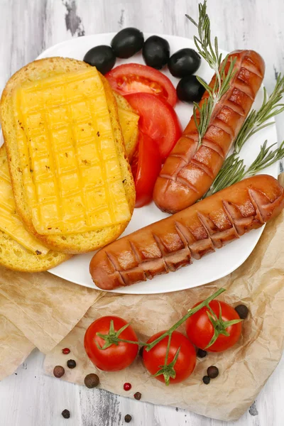 Grilled sausages on wooden table — Stock Photo, Image