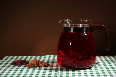 Tablo, koyu arka plan üzerinde bitkisel çay kavanozu