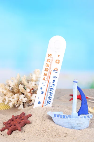 Thermometer  in sand on bright background — Stock Photo, Image