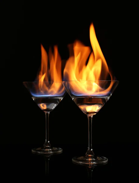 Glasses with burning alcohol on black background — Stock Photo, Image