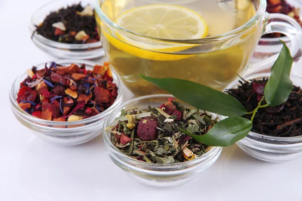 Cup of tea with aromatic dry tea in bowls close up — Stock Photo, Image