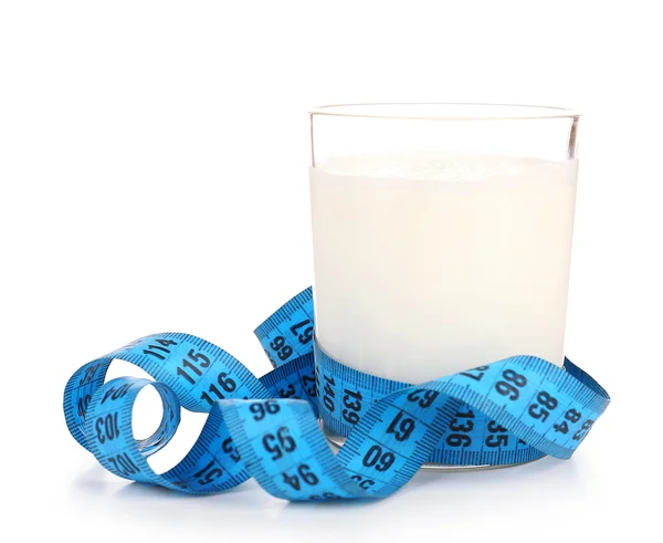 Glass of milk with measuring tape isolated on white — Stock Photo, Image