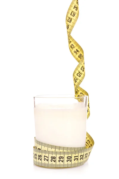 Glass of milk with measuring tape isolated on white — Stock Photo, Image