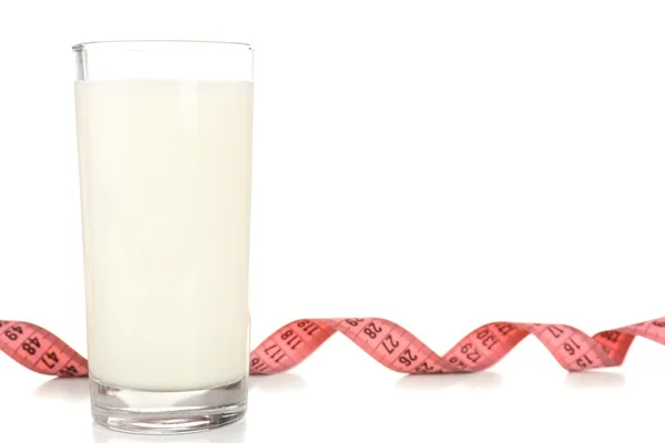 Glass of milk with measuring tape isolated on white — Stock Photo, Image