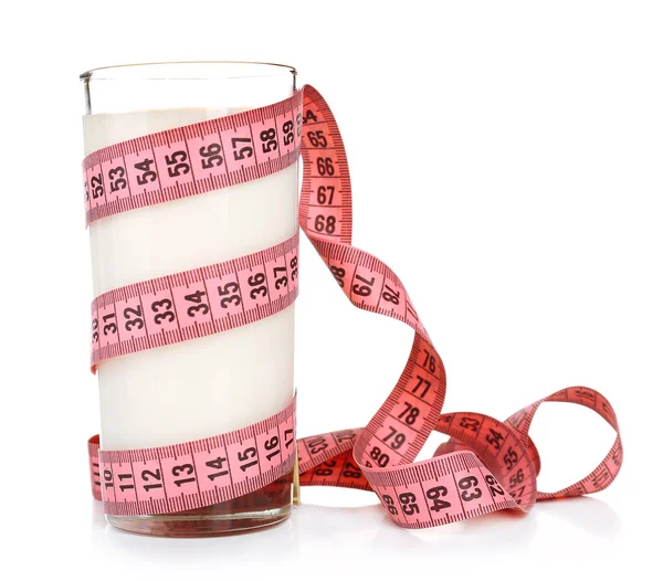 Glass of milk with measuring tape isolated on white — Stock Photo, Image