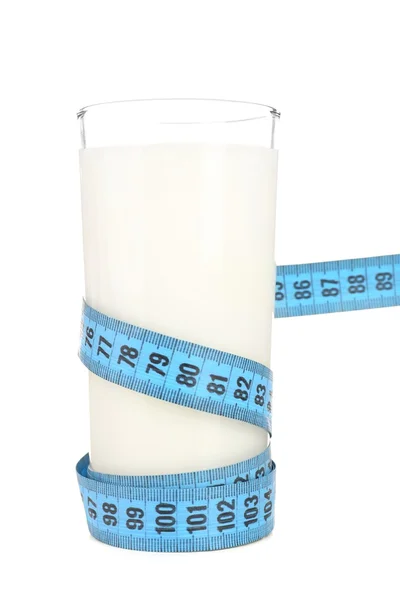 Glass of milk with measuring tape isolated on white — Stock Photo, Image