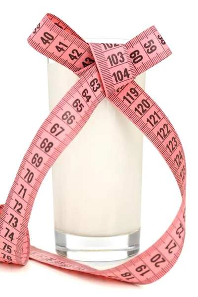 Glass of milk with measuring tape isolated on white — Stock Photo, Image