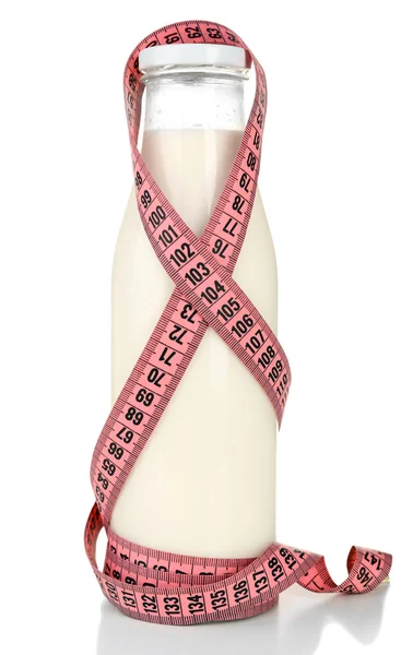 Bottle of milk with measuring tape isolated on white — Stock Photo, Image