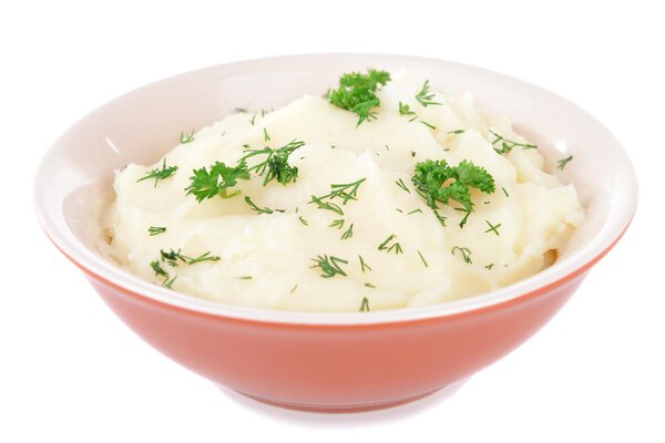 Delicious mashed potatoes with greens in bowl isolated on white 