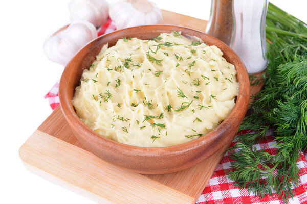 Delicious mashed potatoes with greens in bowl on table close-up