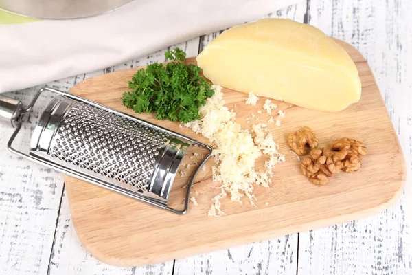 Composition with tasty spaghetti, grater, cheese, on wooden table background — Stock Photo, Image