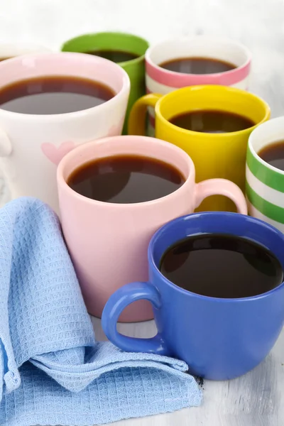 Many cups of coffee on wooden table close up — Stock Photo, Image