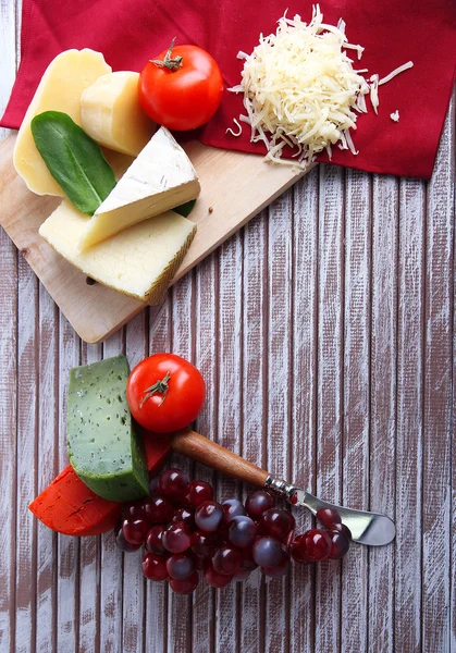 Different Italian cheese on wooden background — Stock Photo, Image