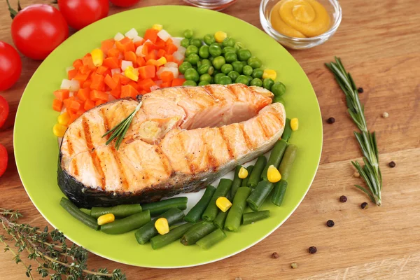 나무 테이블에 야채와 함께 맛 있는 구운된 연어 — 스톡 사진
