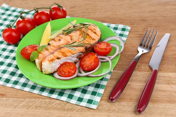 Tasty grilled salmon with vegetables, on wooden table — Stock Photo, Image