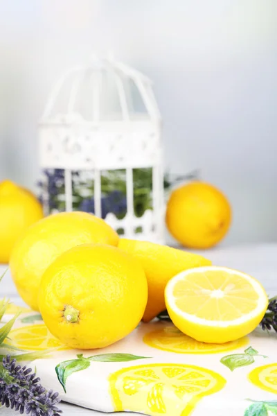 Still life with fresh lemons and lavender on light background — Stock Photo, Image