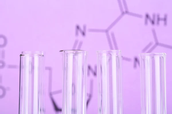 Test tube on written reaction formula background, close-up — Stock Photo, Image
