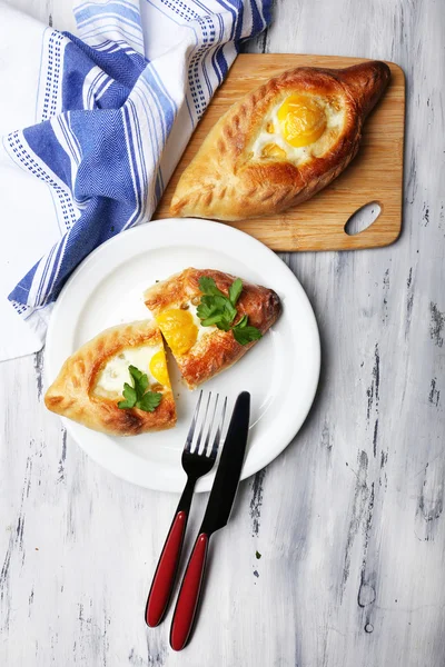 Ajarian khachapuri on wooden table — Stock Photo, Image