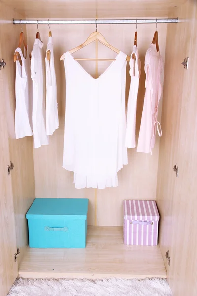 Female clothes on hangers in wardrobe — ストック写真