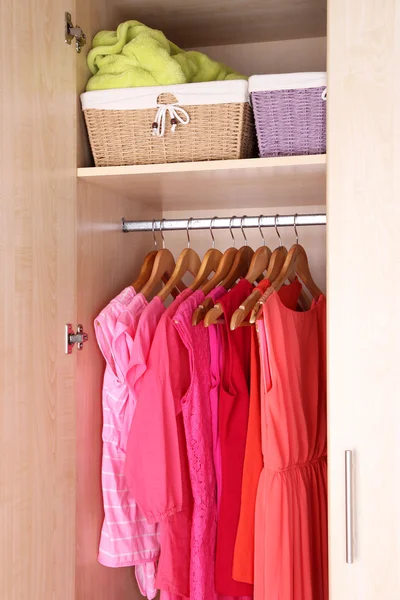 Female clothes on hangers in wardrobe — 스톡 사진