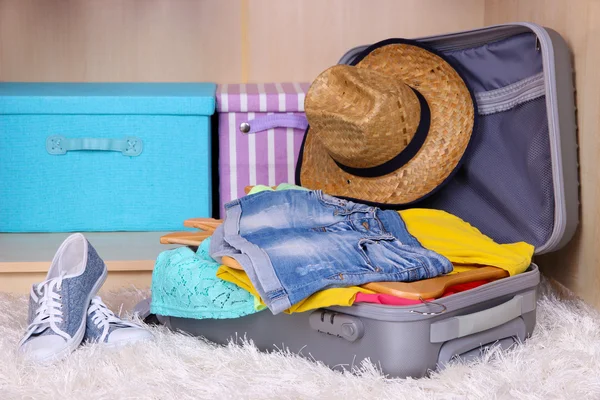 Female clothes in suitcase in room — Stock Photo, Image