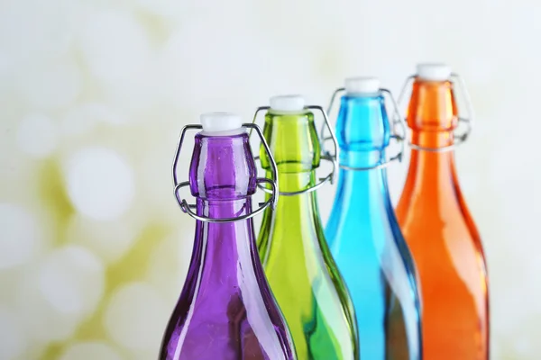 Botellas coloridas sobre fondo claro —  Fotos de Stock