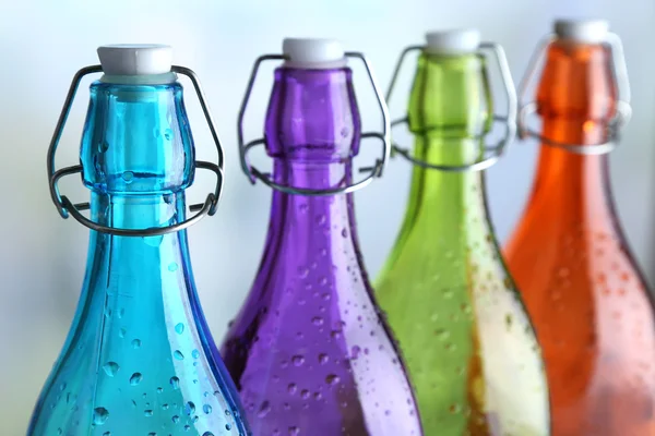 Colorful bottles on light background — Stock Photo, Image