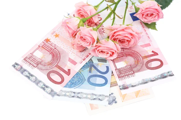 Mooie rozen en geld, geïsoleerd op wit — Stockfoto