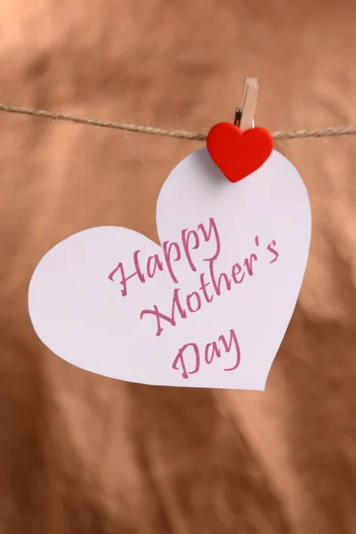 Happy Mothers Day message written on paper heart on brown background — Stock Photo, Image