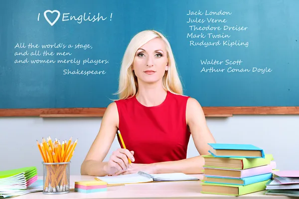 Young teacher sitting in school classroom — Stock Photo, Image