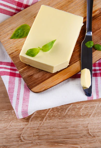 Tasty butter on wooden cutting board — Stock Photo, Image