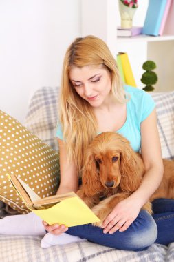 cocker spaniel odasındaki kanepenin üzerine ile güzel genç kadın