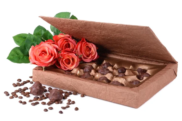 Delicious chocolates in box with flowers isolated on white — Stock Photo, Image