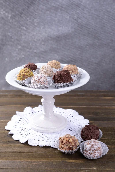 Set of chocolate candies on table on grey background — Stock Photo, Image
