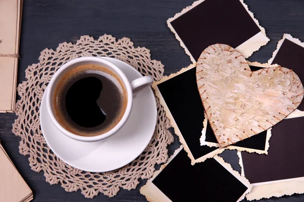 Composition with coffee cup, letters and old blank photos, on wooden background — Stock Photo, Image