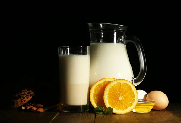 Eggnog with milk and eggs on table and black background — Stock Photo, Image