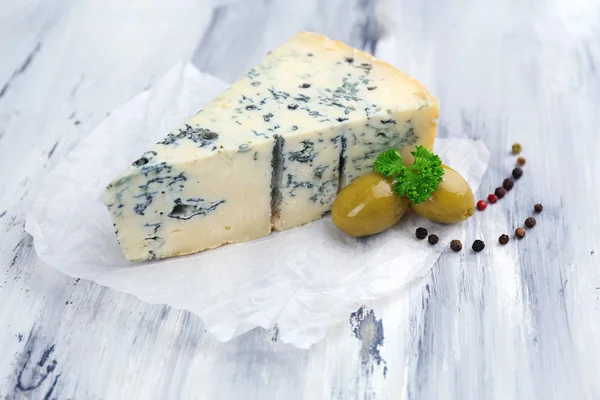 Tasty blue cheese on old wooden table — Stock Photo, Image