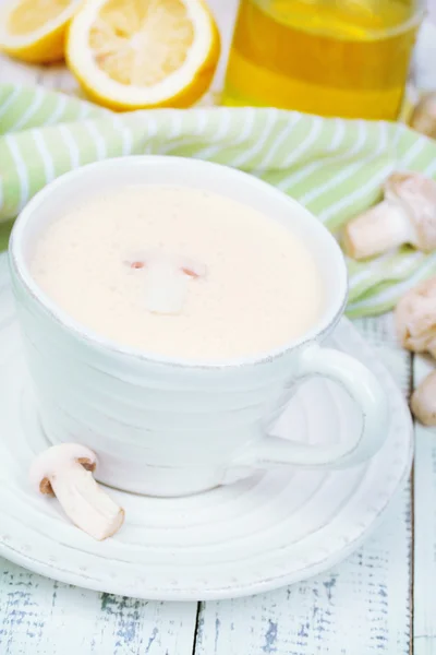 Delicate mushroom sauce in cup on wooden table close-up — Stock Photo, Image