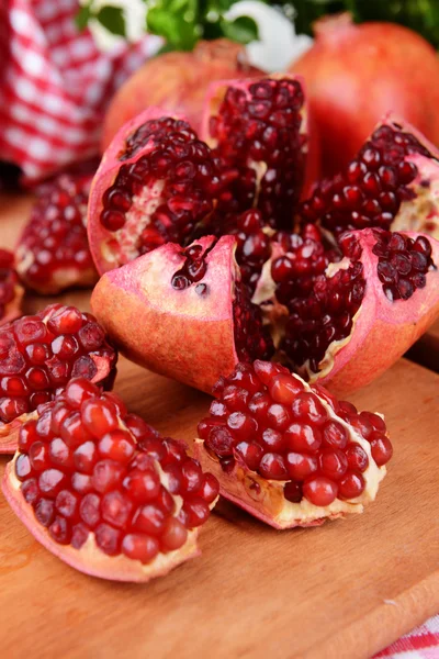 Ripe pomegranates on table close-up — Stock Photo, Image