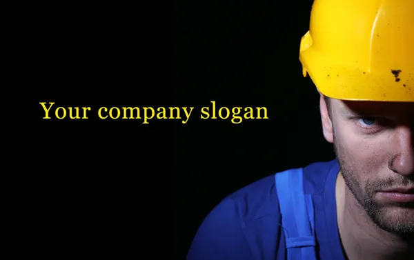 Portrait of young worker on dark background — Stock Photo, Image