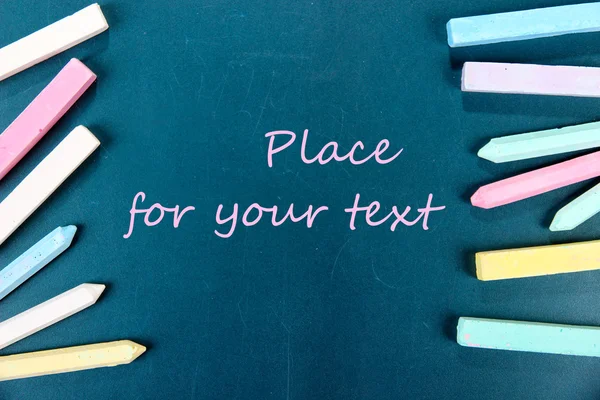 Colorful chalks on school desk — Stock Photo, Image