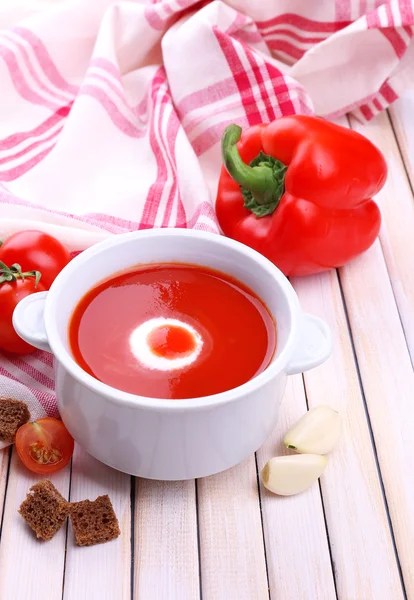 Tasty tomato soup and vegetables on wooden table — Stock Photo, Image