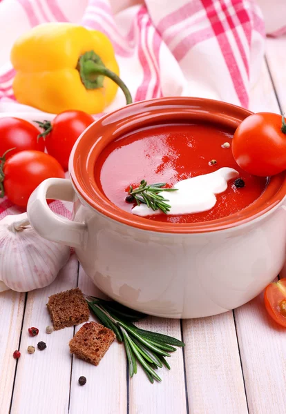 Tasty tomato soup and vegetables on wooden table — Stock Photo, Image