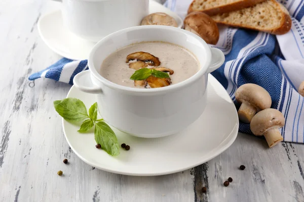 Mushroom soup in white pots, on napkin, on wooden background — Stock Photo, Image