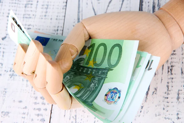 Money in wooden hand — Stock Photo, Image