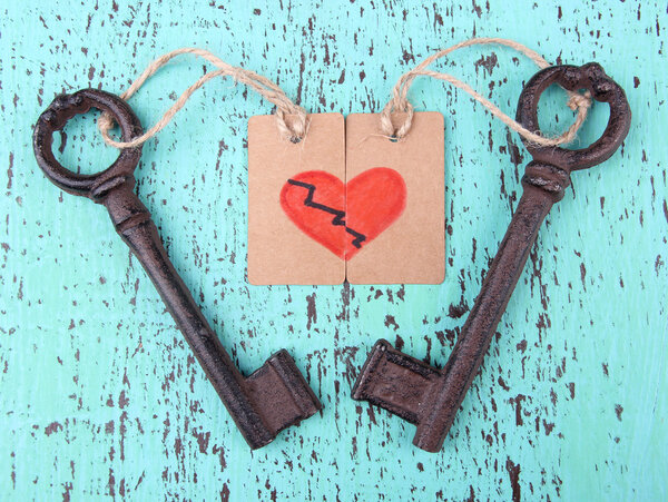 Keys to love, Conceptual photo. On color wooden background